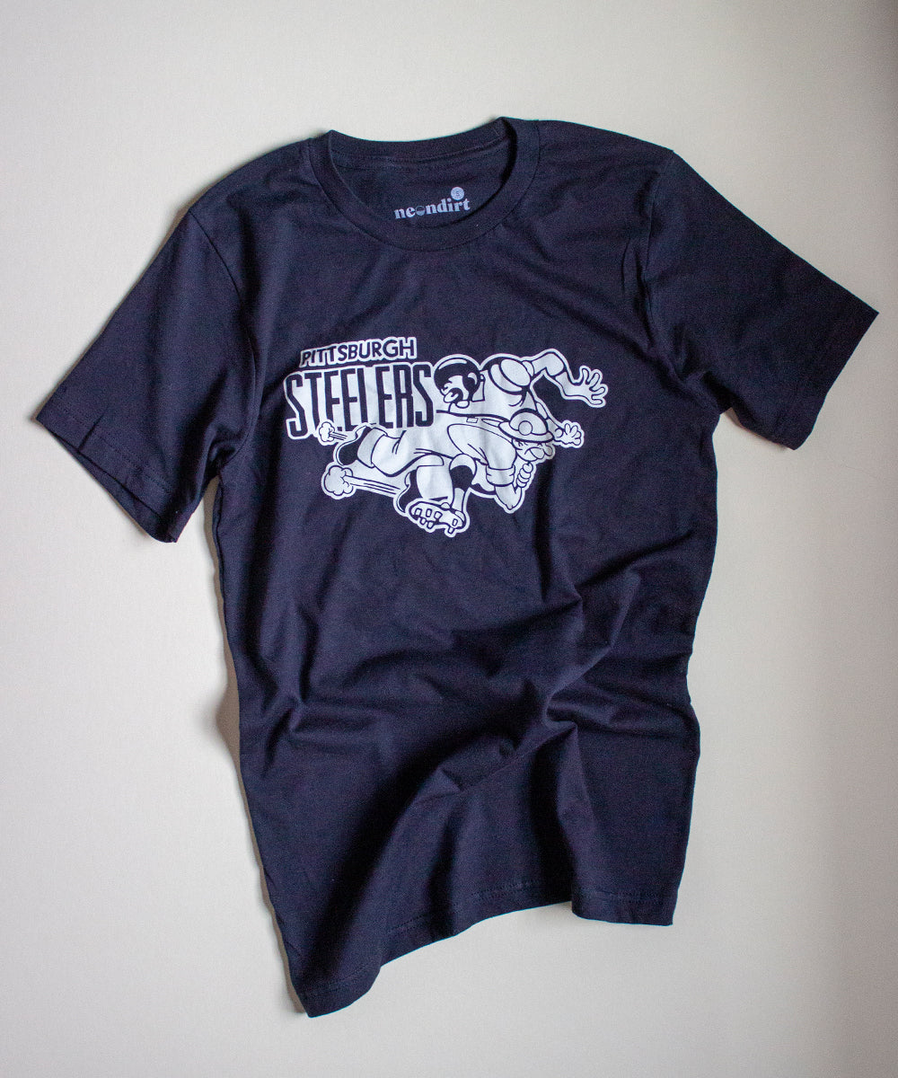 Our Vintage Black Forgotten and Refreshed: Pittsburgh Steelers tee highlights a monochrome retro white design. the right shoulder stacked text reads "Pittsburgh Steelers" featuring the classic "steel worker" tackling a football player.
